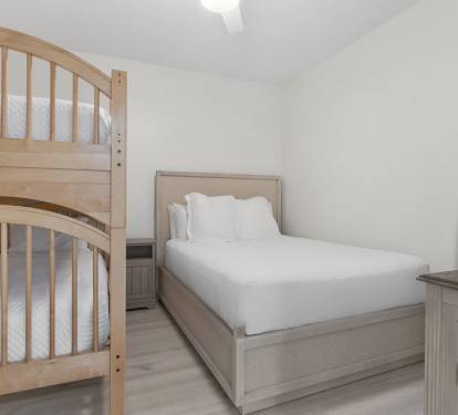 This cozy guest bedroom features a queen bed and twin-over-twin bunk—perfect for kids or extra guests.