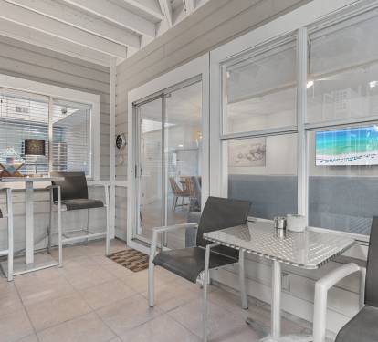 Enjoy al fresco dining or a quiet morning coffee on the screened-in patio, just steps from the living room.