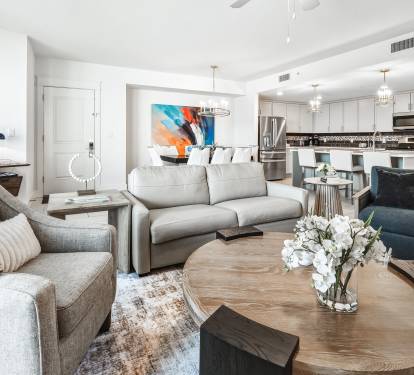 Relax in your stylish open-concept living space featuring plush seating, modern kitchen with sleek appliances, and thoughtful design touches throughout.