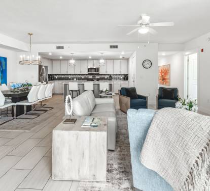 Unwind in your spacious open-concept living space, where modern comfort meets coastal style with plush seating and a fully-equipped kitchen.