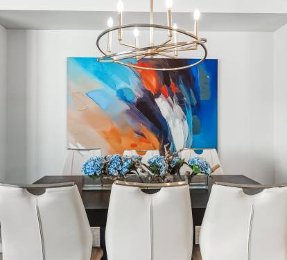 Your elegant dining space features a striking chandelier and bold artwork, perfect for memorable meals with loved ones.