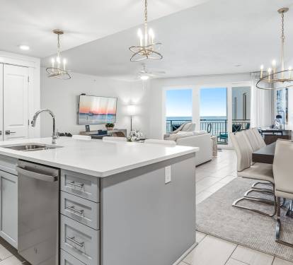 Your gourmet kitchen flows seamlessly into the open living space, where ocean views frame every moment of your beachfront getaway.