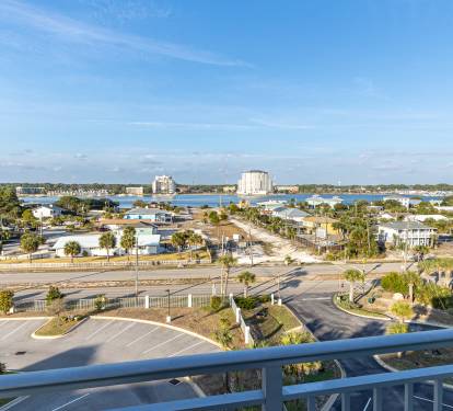 Expansive coastal view showcasing the peaceful neighborhood with waterfront access and distant high-rises defining the skyline.