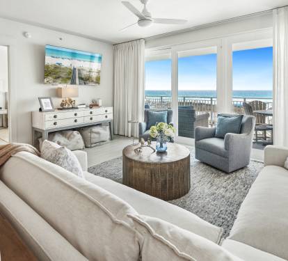 Sink into plush coastal comfort where your living room opens to breathtaking ocean views through floor-to-ceiling windows.