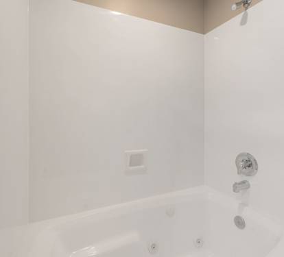 Slip into this pristine bathtub for a relaxing soak after your adventures, with clean white surroundings.