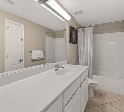 Spacious bathroom features a tub, fresh towels, and clean modern finishes for ultimate relaxation.