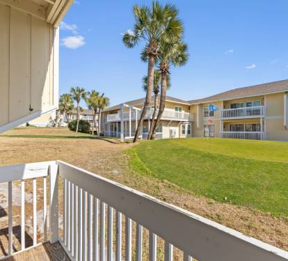 Enjoy peaceful resort views from the private patio overlooking the lush grounds and golf course area at Sandpiper Cove Resort. This relaxing outdoor space is perfect for morning coffee, evening drinks, and soaking in the coastal atmosphere.