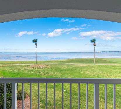 Unobstructed views of Sandestin-s golf course and the Choctawhatchee Bay from this corner-unit balcony, offering a peaceful retreat for golfers.