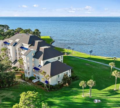 Aerial view of this Sandestin Golf & Beach Resort condo community overlooking the Choctawhatchee Bay, just minutes from multiple championship golf courses and resort amenities.