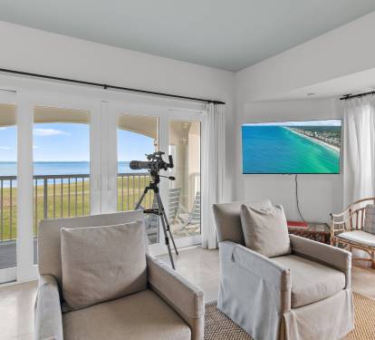 Bright living space with expansive windows showcasing Sandestin-s championship golf course and bay views. Perfect golfer-friendly vacation rental located directly inside Sandestin Golf & Beach Resort.
