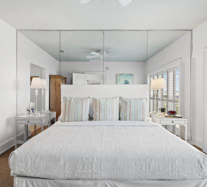 Spacious primary bedroom with a king bed inside Sandestin Golf & Beach Resort, offering a comfortable retreat for golfers after a full day on nearby championship courses.