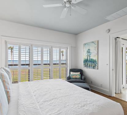 Spacious primary bedroom with access to balcony views overlooking the golf course at Sandestin Golf & Beach Resort. A peaceful retreat for golfers after a full day on the links.