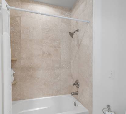 Guest bathroom featuring a tub and shower combination, offering added convenience for golf groups staying inside Sandestin Golf & Beach Resort.