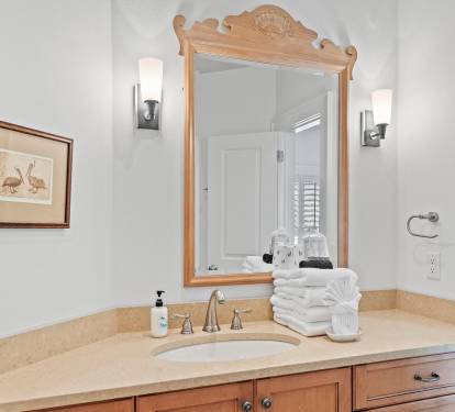 Guest bathroom vanity with spacious counter and sink, providing added comfort and functionality for golf groups staying inside Sandestin Golf & Beach Resort.