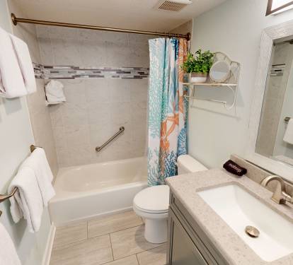 Refresh in your private bathroom with marble counters, tub-shower combo, and plush towels ready for your comfort.