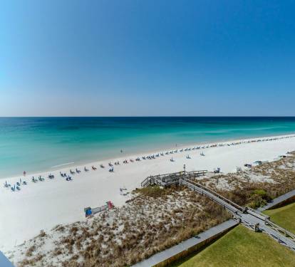 Stunning beachfront location with pristine white sand, turquoise waters, and direct beach access via wooden walkway.