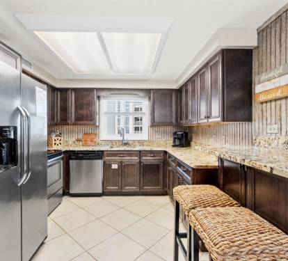 Your fully equipped kitchen features granite counters, stainless appliances, and warm wood cabinets for effortless meal preparation.