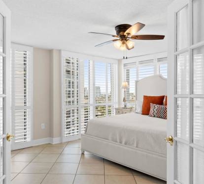 Drift off in your sun-soaked sanctuary with stunning city views through plantation shutters and gentle ceiling fan breezes.