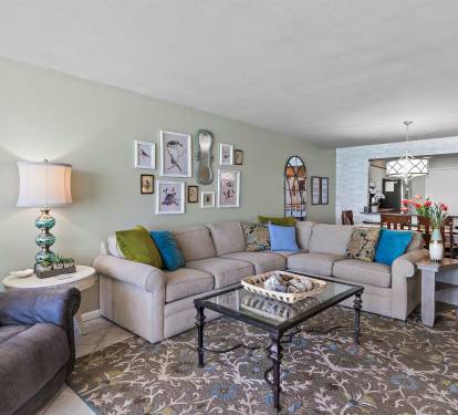 Settle into your spacious living area with plush sectional seating, colorful accent pillows, and thoughtful touches that make you feel right at home.