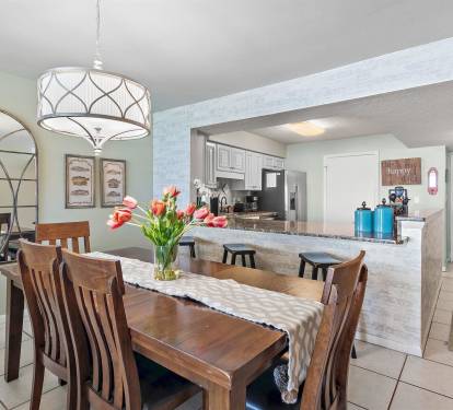 Gather around your spacious dining table with fresh tulips while the open kitchen invites easy meal prep and conversation.