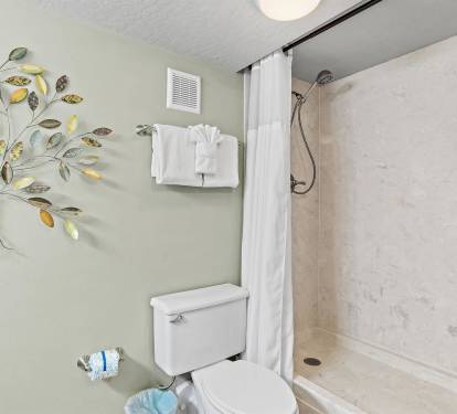 Refresh in your private bathroom featuring a spacious walk-in shower and cheerful tree artwork that brightens your morning routine.