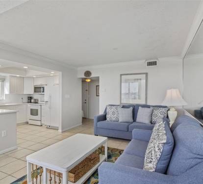 Unwind in your bright, open living space where coastal blues meet crisp whites, creating the perfect backdrop for memorable vacation moments.