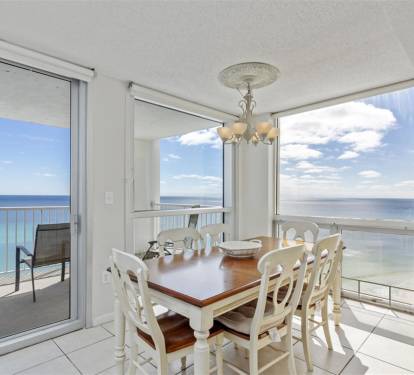 Enjoy meals with breathtaking ocean views through floor-to-ceiling windows that frame the endless blue horizon from your elegant dining space.
