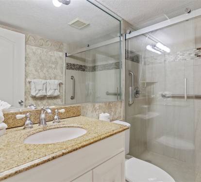 Pamper yourself in this sparkling bathroom with granite counters, glass-enclosed shower, and fresh towels awaiting your arrival.