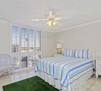 Drift off to sleep in your comfortable bed while the coastal breeze flows through plantation shutters, creating a peaceful beachside retreat.