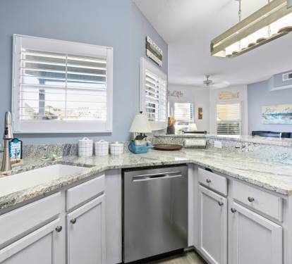 Your spacious kitchen features granite countertops, stainless steel appliances, and coastal touches that make meal prep feel like a breeze.