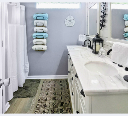 Step into your spa-like bathroom with marble countertops, soft towels, and coastal decor that creates a serene retreat for your morning routine.