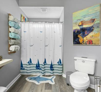Freshen up in your coastal-themed bathroom, complete with nautical artwork and soft towels ready for your comfort.