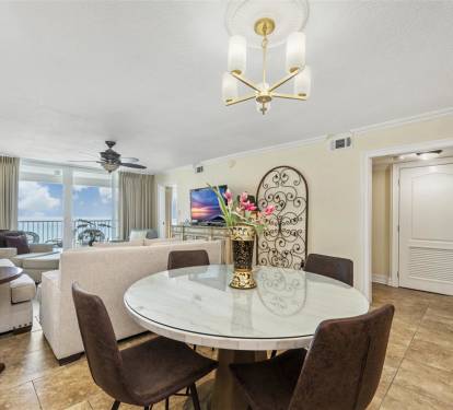 Your elegant dining area flows into the living space, perfect for memorable meals with breathtaking ocean views beyond.