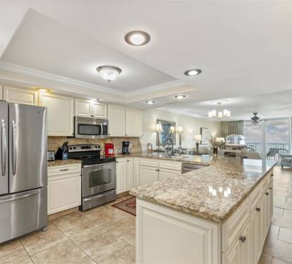 Your spacious kitchen features gleaming granite counters and stainless appliances, perfect for preparing meals during your stay.