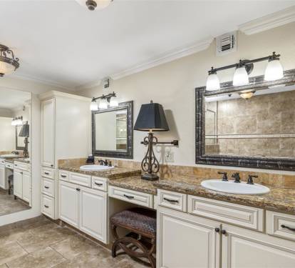 Luxurious dual vanity bathroom with granite counters and elegant lighting creates your perfect morning routine sanctuary.