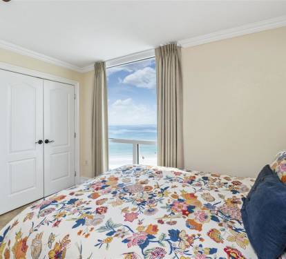 Wake up to stunning ocean views from your coastal bedroom, where vibrant florals and woven textures create a cheerful seaside retreat.