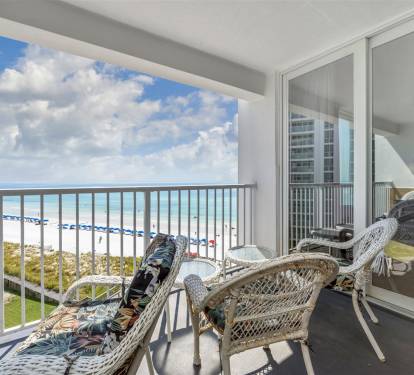 Unwind on your private balcony with stunning ocean views, comfortable wicker seating, and endless blue horizons stretching before you.