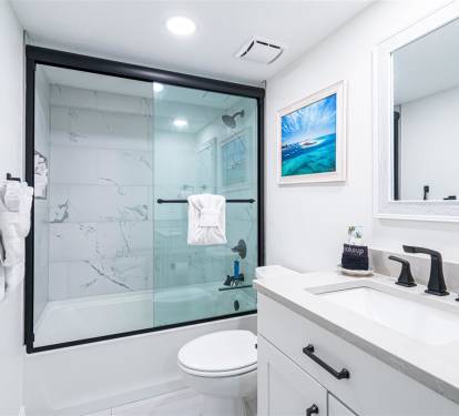 Step into your pristine bathroom featuring a luxurious marble-tiled shower and modern fixtures for your ultimate comfort.