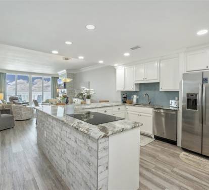 Your spacious kitchen flows into the living area, perfect for cooking while chatting with loved ones on your oceanfront getaway.