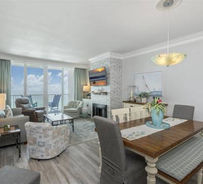 Relax in your elegant living space with ocean balcony access, cozy fireplace, and open dining area perfect for memorable meals.