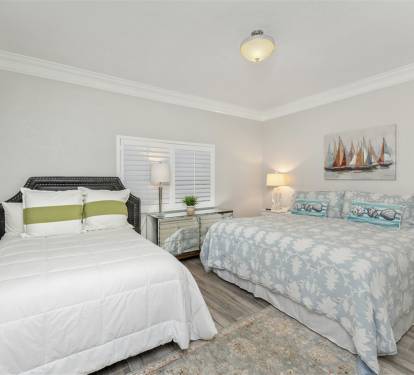 Wake up refreshed in your peaceful bedroom featuring two comfortable beds with coastal-inspired décor and soft natural lighting.