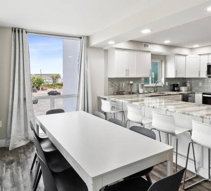 Your modern kitchen flows seamlessly with the dining area, featuring gleaming granite counters and contemporary finishes perfect for memorable meals.