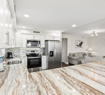 Your gorgeous marble kitchen flows seamlessly into the cozy living area, perfect for cooking and relaxing together.