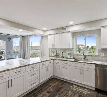 Your spacious modern kitchen features granite counters, stainless appliances, and bright windows overlooking the vibrant neighborhood below.