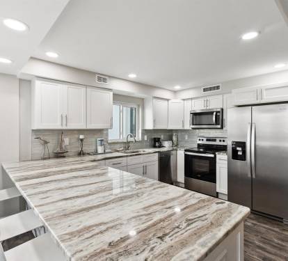 Your fully equipped kitchen features modern appliances, marble countertops, and ample space for preparing memorable meals during your stay.