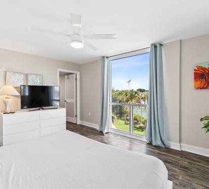 Wake up to serene views of lush greenery from your comfortable bedroom, complete with modern entertainment and peaceful natural light.