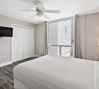 Rest peacefully in your bright, modern bedroom with cooling ceiling fan, flat-screen TV, and city views from your window.