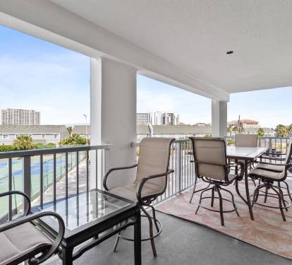Unwind on your private balcony with comfortable seating and sweeping views of the city skyline and nearby coastline.