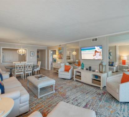 Relax in your elegantly appointed living space featuring plush seating, coastal decor, and modern entertainment.