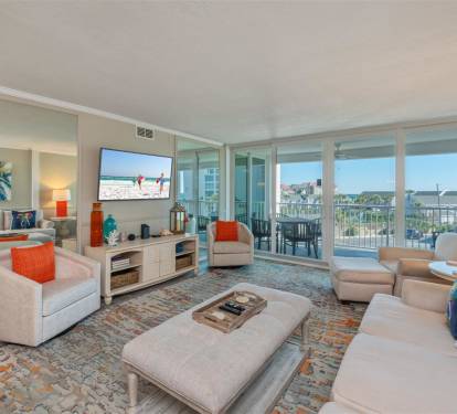 Relax in your bright living room with panoramic views, comfortable seating, and vibrant coastal touches that make you feel right at home.